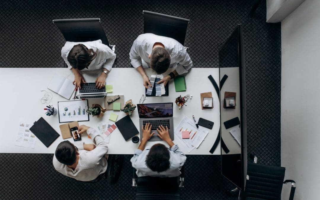 four working men on white desk